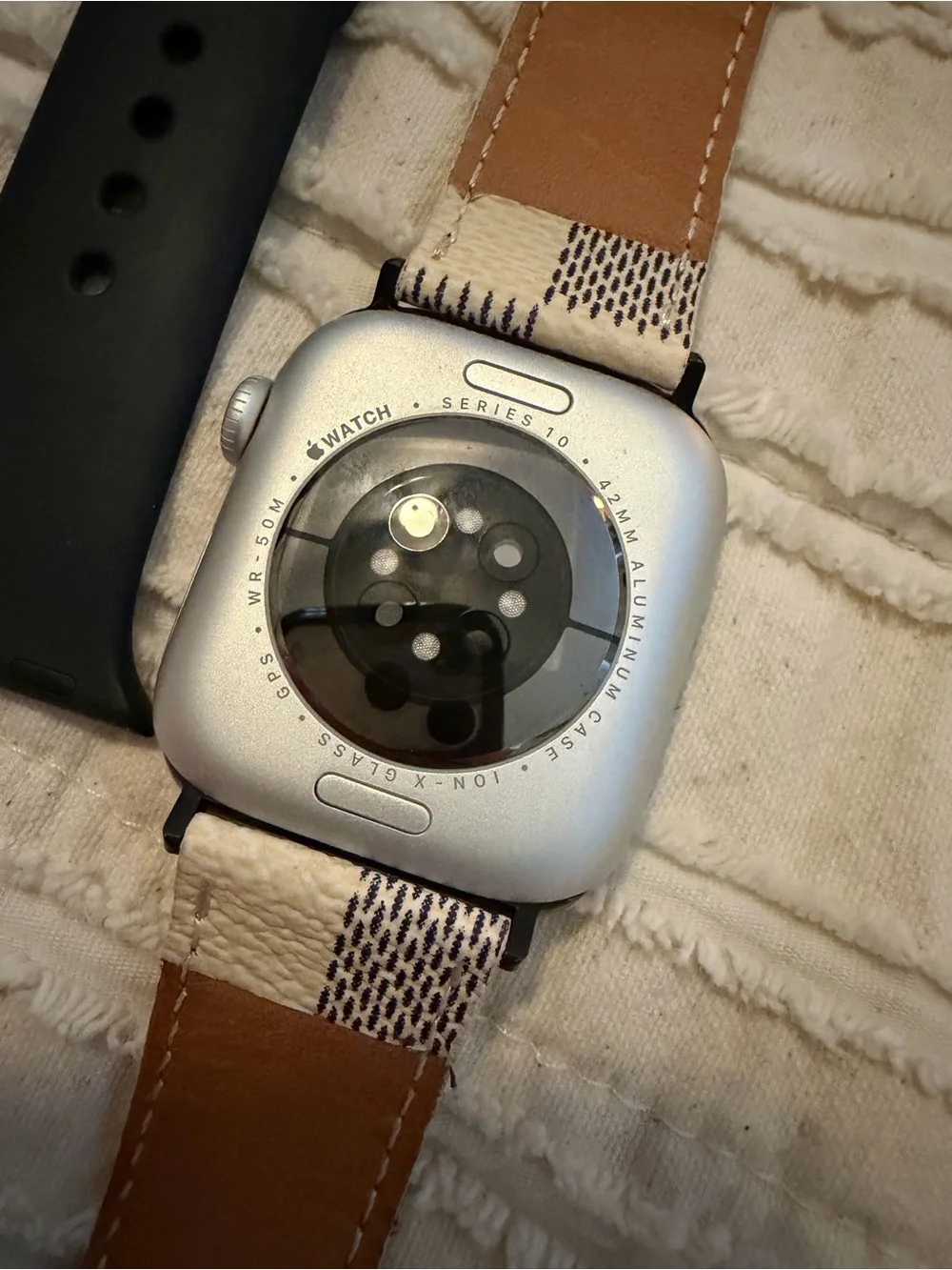 Apple Watch with Black, Beige, White and Checkered Bands